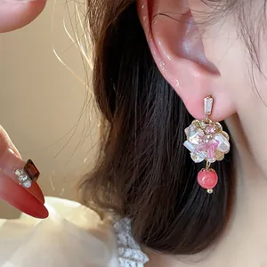 Exquisite 14K gold plated flower stud earring featuring pink crystal and red bead dangle