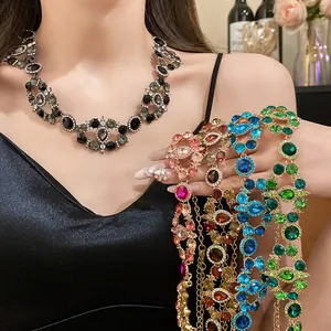 Close-up view of vintage palace style necklaces with colorful rhinestones on a model.