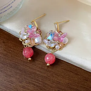 Macro view of 14K gold plated flower earrings with pink crystals and pearls jewelry