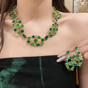 Close-up detail of luxury vintage green crystal necklace and matching earring set on model