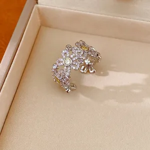 Elegant silver-tone open ring with hollow flower design and yellow zircon accents