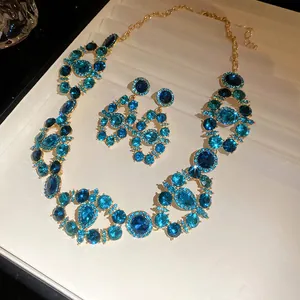Close-up of vintage court style blue crystal necklace and earring jewelry set with sparkles