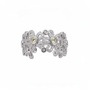 Elegant floral hollow open ring inlaid with sparkling cubic zirconia and yellow stones.
