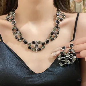Close-up of the vintage palace style rhinestone necklace and earring set on model