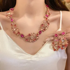Close-up of a vintage pink crystal necklace and earrings set worn by a female model.