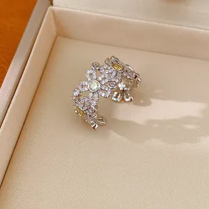 Exquisite silver-toned hollow flower open ring encrusted with yellow and white zircons