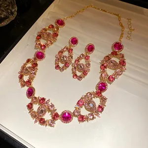 Close-up of vintage jewelry set with sparkling pink and magenta rhinestones