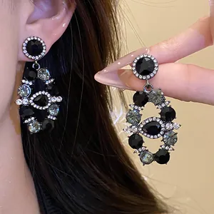 Detailed view of luxury vintage palace style earrings with black and grey crystals
