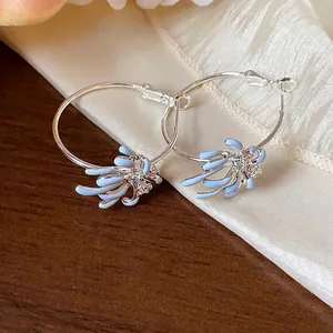 Elegant light blue enamel floral hoop earrings with sparkling zircon accents on silver pins
