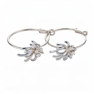 Elegant silver hoop earrings with zircon floral enamel detail on white background