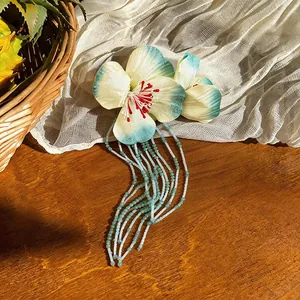 Exquisite fabric flower hair clip with long glass bead tassels for a vacation look