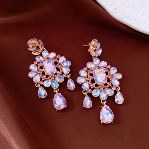 Detailed macro view of silver needle earrings with iridescent crystals and pink stones