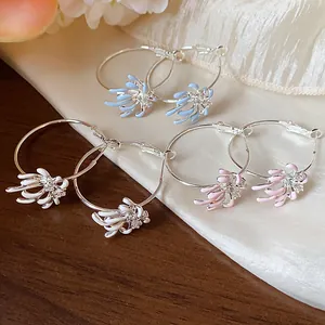 Detailed view of silver zircon enamel floral hoop earrings in white, blue, and pink colors.