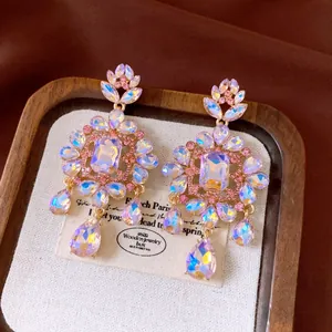 Luxury rhinestone flower drop earrings with square and teardrop stones in gold finish