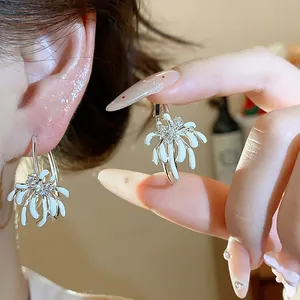 High-quality detailed view of white oil-dripping flower hoop earrings with zircon accents