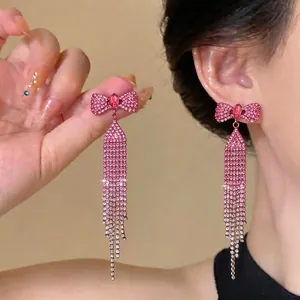 Elegant pink rhinestone bow tassel earrings with a sparkling and sophisticated design