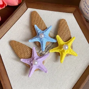 Bohemian starfish pearl hair clips set in blue, yellow, and purple for seaside vacations.