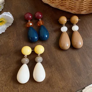 Detailed view of multi-colored resin waterdrop earrings showcasing glossy texture and design
