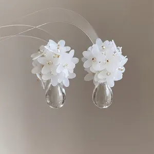 Elegant white flower cluster earrings featuring clear water-drop shaped glass pendants