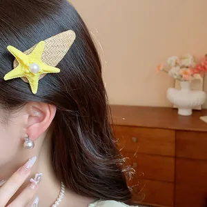 Detailed side view of a yellow starfish pearl hair clip worn on long brunette hair