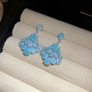Détail macro de boucles d'oreilles élégantes en zircon bleu avec gouttes vintage.