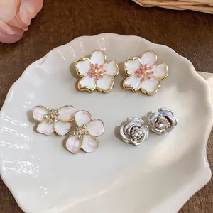 Exquisite set of three floral stud earrings featuring enamel cherry blossoms and roses
