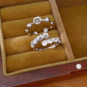 Elegant minimalist silver-tone open rings with zircon stones displayed in a velvet box