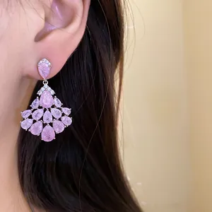 Vue détaillée de boucles d'oreilles pampilles gouttes en zircon rose, style rétro chic.