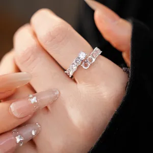 Sparkling silver open ring featuring zircons and resin beads on elegant model hand