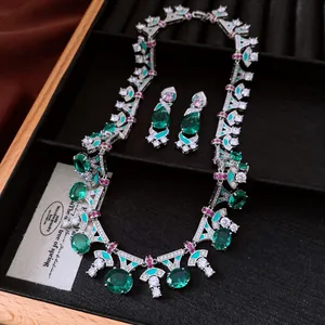 Detailed shot of a vintage luxury jewelry set featuring green oval zircon necklace and earrings