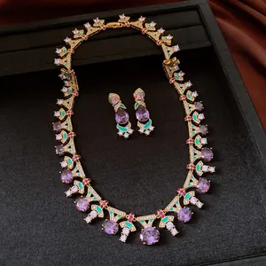 Detailed view of a vintage jewelry set with purple zircons and green enamel accents.