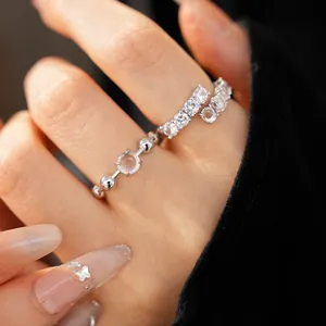 Macro view of an elegant silver open ring featuring zircon and round resin stones