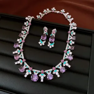 Close-up detail of luxury vintage zircon jewelry set with purple stones and green enamel