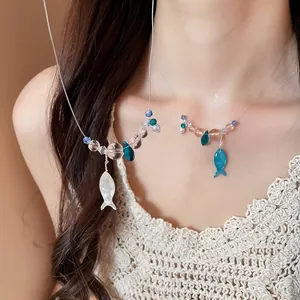 Close-up detail of beaded fish charms necklace worn by model in soft light