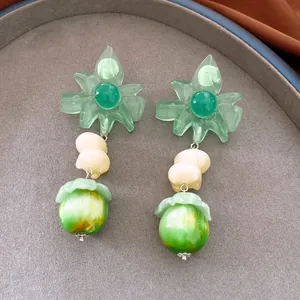 Close-up detail of sweet green resin flower dangle earrings with elegant marbled beads