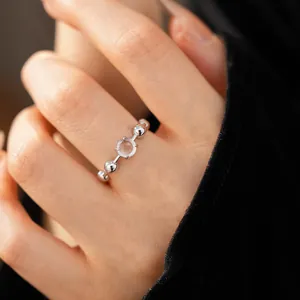 Detailed view of a silver minimalist open ring with round beads and translucent resin stone