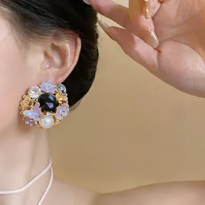 Close-up detail of a vintage palace-style earring with purple butterflies, flowers and pearls