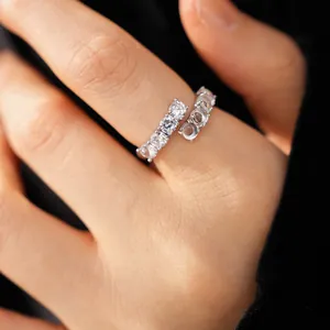Detailed view showing the sparkling zircons and smooth resin stones on the open wrap ring.