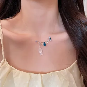 Close-up view of a fresh beaded necklace featuring a cute pearlescent fish pendant charm