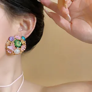 Elegant close-up view of vintage enamel stud earring with pearl and butterfly floral design