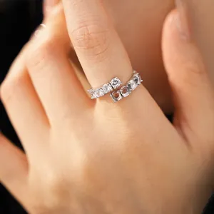 Close-up of a zircon resin open ring with a minimalist wrap-around design on a finger.