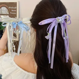 Elegant rhinestone ribbon bow hair clip with tassel and pearl detail for women
