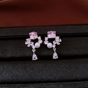 Elegant silver needle stud earrings with pink zircon, pearl, and teardrop crystal detail.
