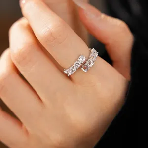 Close-up of elegant silver open ring with cubic zircon and resin stones on a hand