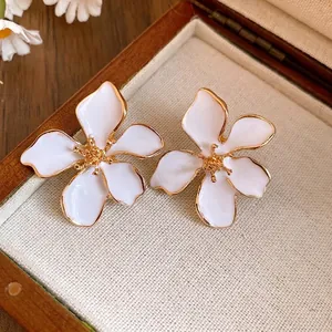 Elegant white flower stud earrings with gold trim and silver needle post for women