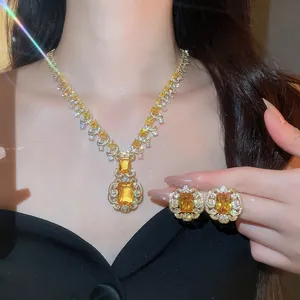 Detailed macro view of yellow zircon necklace and earrings with elegant lace border