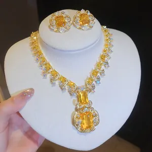 Detailed view of yellow square-cut zirconia jewelry set with floral halo accents.