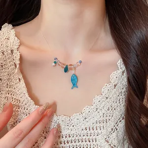 Close-up detail of a summer resin beaded choker necklace featuring cute blue fish charms