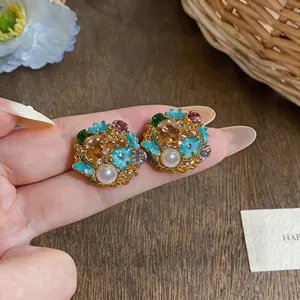 Vintage palace style floral stud earrings with enamel, pearls, and colorful crystals.