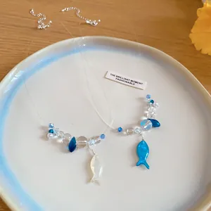 Detailed view of summer resin beaded fish necklace with clear invisible wire
